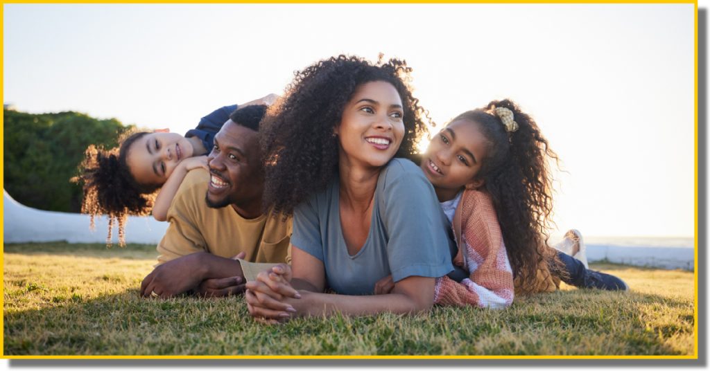 A family of four relaxing on the grass