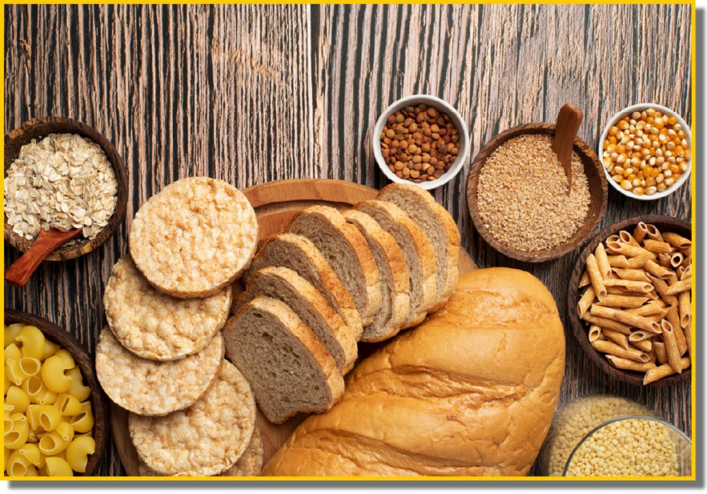 An assortment of bread, cereals, and various foods displayed together on a table.