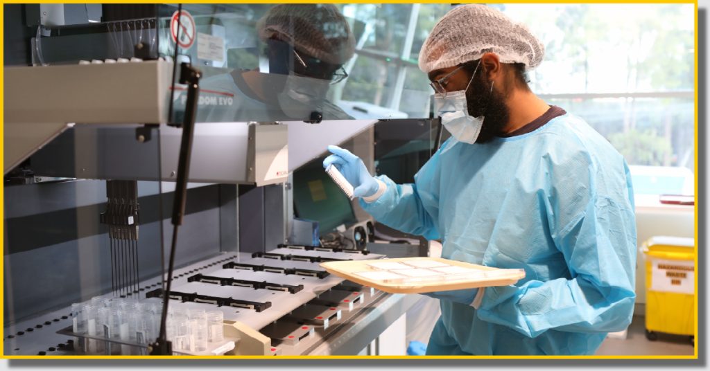 A man in a lab coat and gloves operates one of R-Biopharm's products.