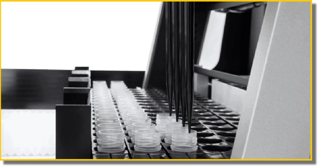 A laboratory machine displaying a tray filled with various test tubes, ready for scientific analysis.