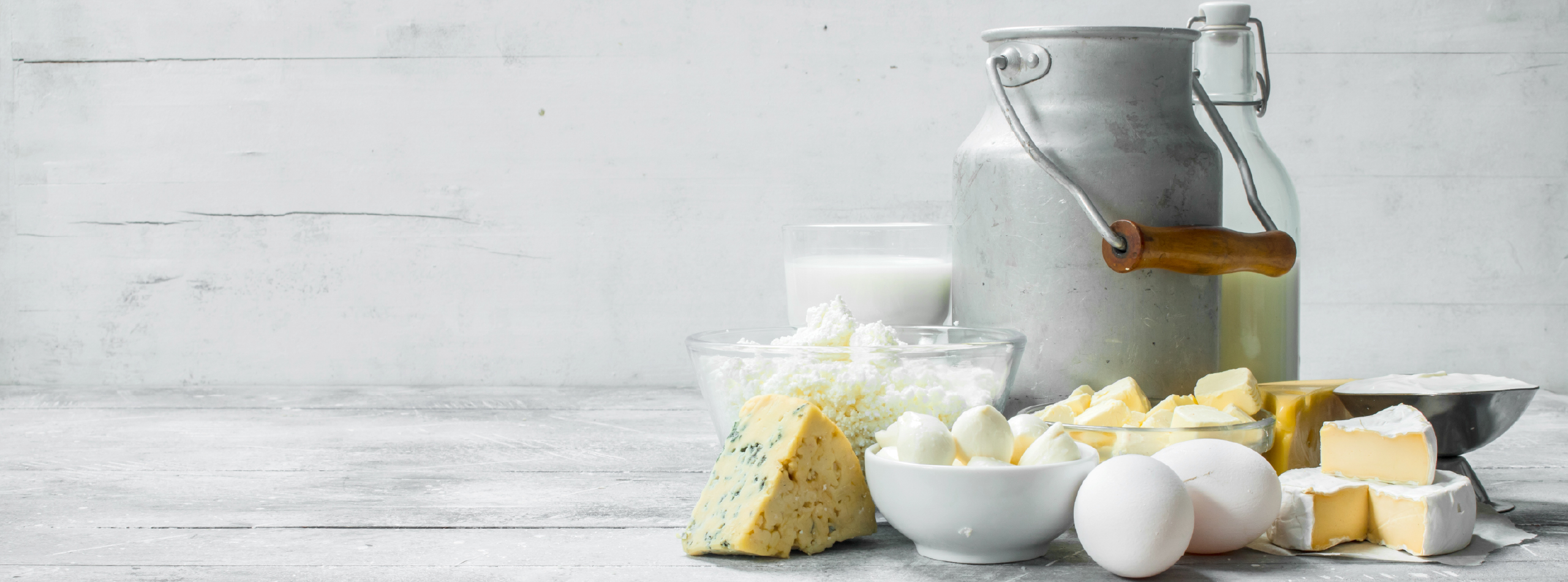 A variety of dairy products including milk, cheese, eggs, and butter