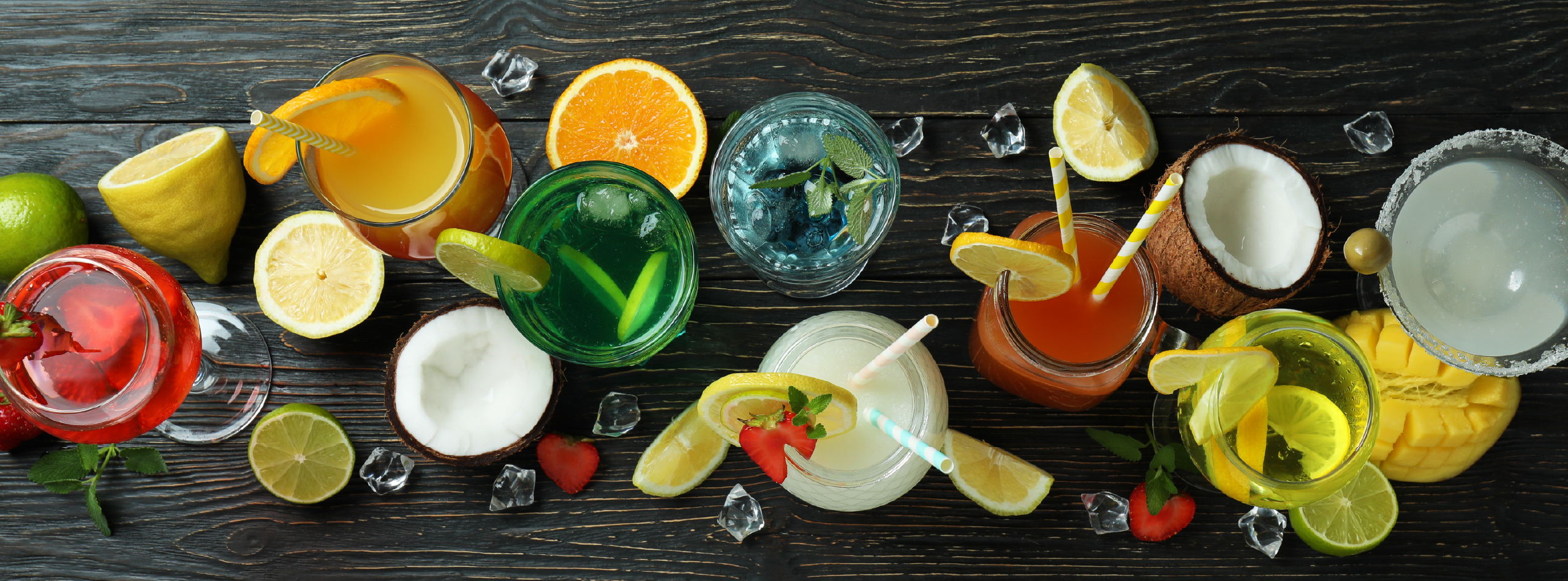 A table displaying a variety of colourful drinks in different glasses