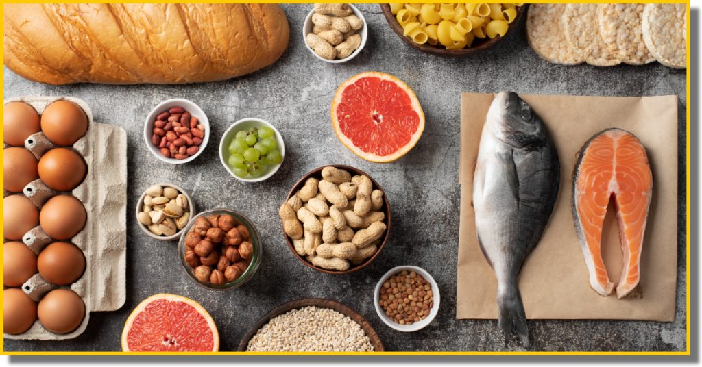 A colourful assortment of foods commonly associated with allergens, including fruits, vegetables, nuts, and whole grains on a wooden table.