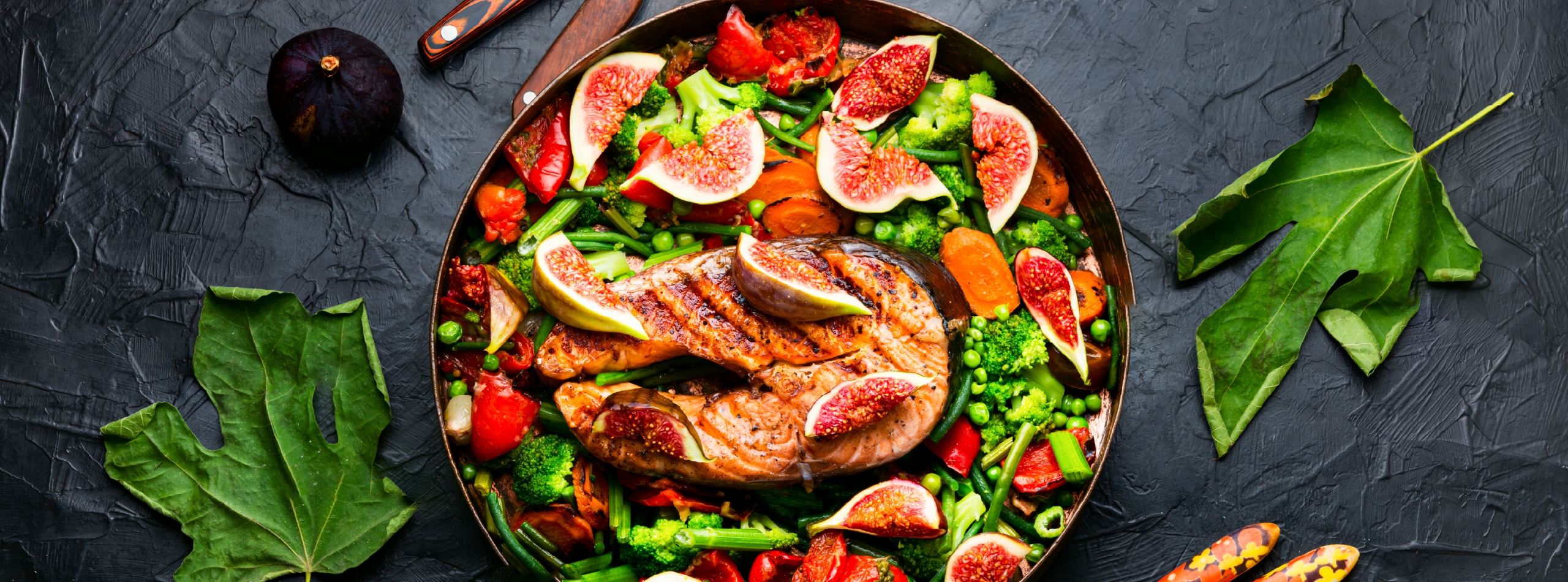 A plate filled with a colourful salad featuring fresh vegetables and slices of meat