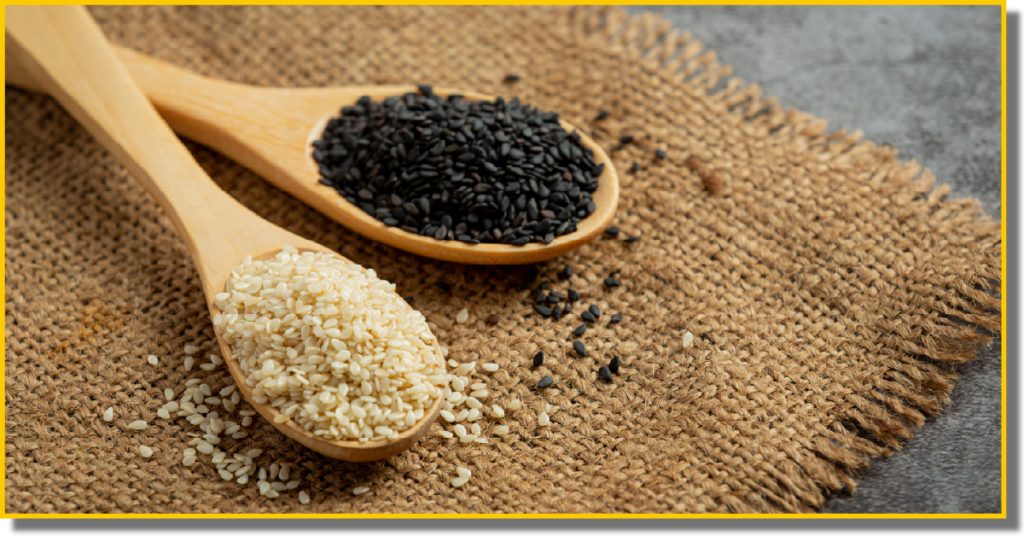 A close-up of black and white sesame seeds displayed together on a canvas mesh.