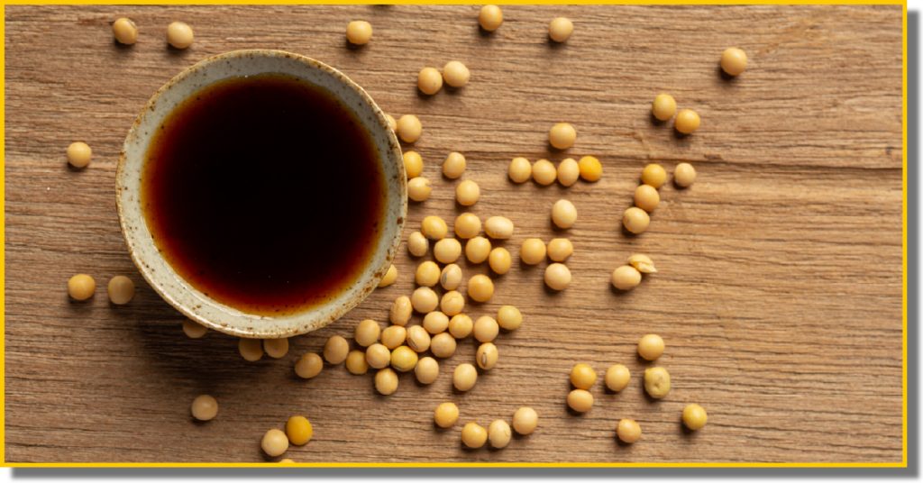 soybeans and a bowl of soy sauce displayed on a wooden counter