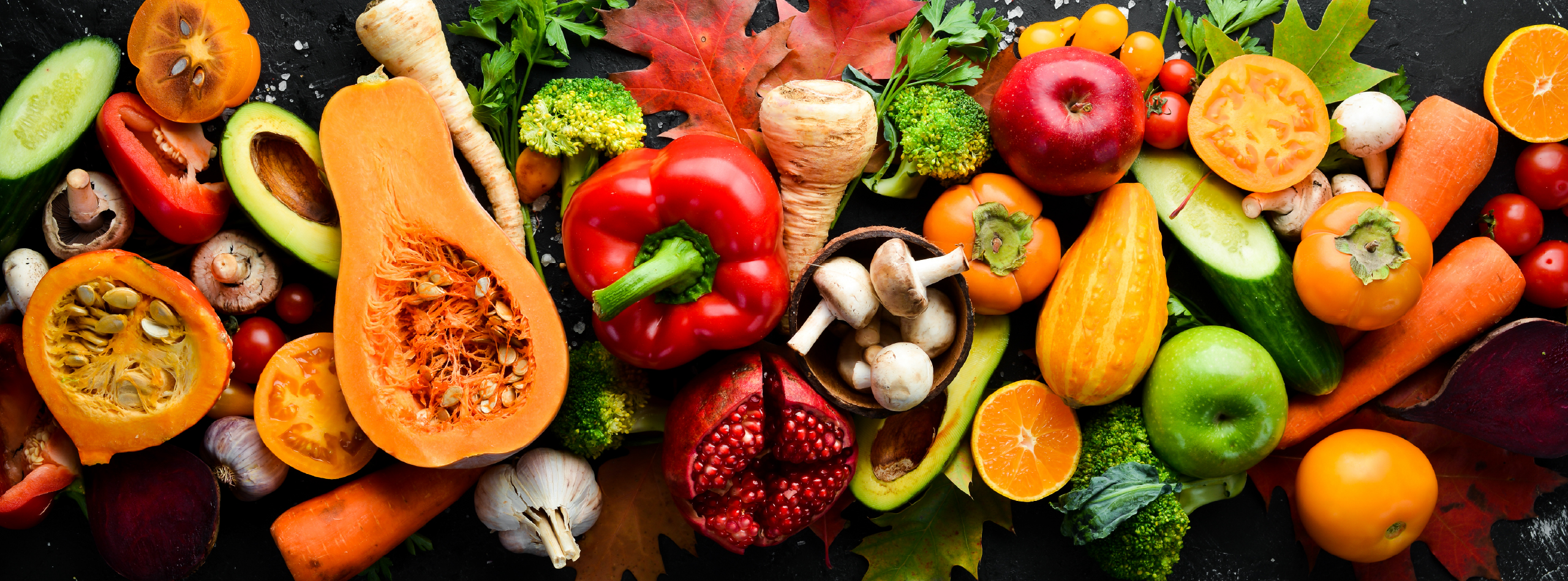 A vibrant assortment of fruits and vegetables displayed on a black background